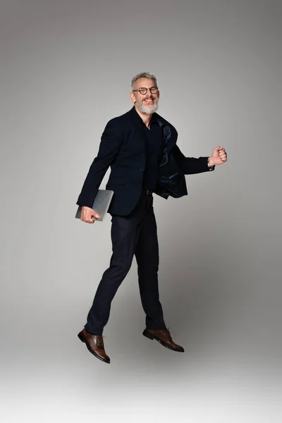 Full Length Cheerful Man Grey Hair Holding Laptop While Levitating — Stock Photo, Image