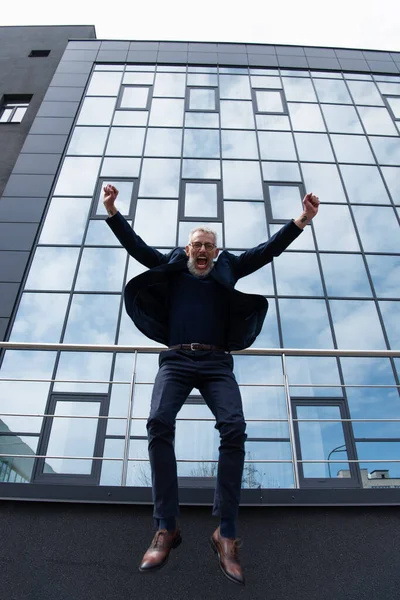 Full Length Mature Man Grey Hair Glasses Jumping Modern Building — Stock Photo, Image