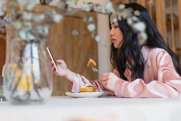 Smiling Young Asian Woman Silk Pajamas Eating Pancakes Fork Looking — Stock Photo, Image