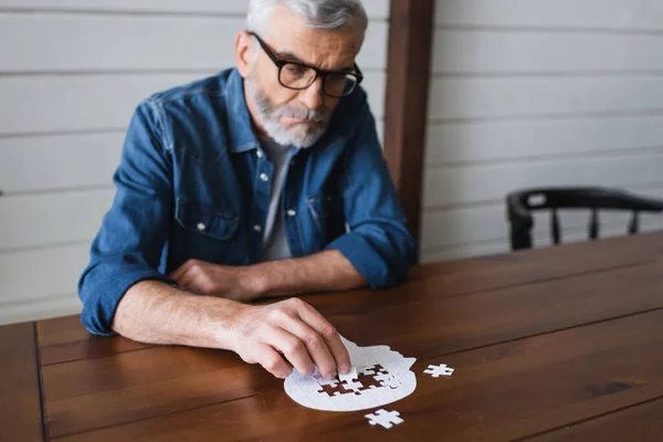 Jigsaw Blurred Senior Man Eyeglasses Table — Stockfoto