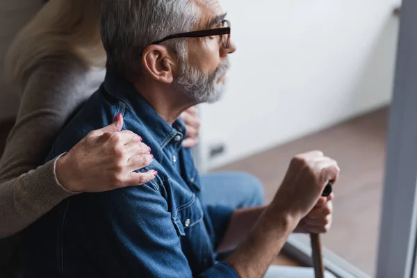 Side View Woman Blurred Background Hugging Husband Crutch Home — Stock Photo, Image