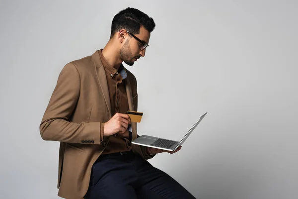 Side View Arabian Businessman Holding Credit Card Laptop Isolated Grey — Stock Photo, Image