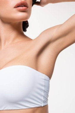 partial view of young woman in white top with smooth armpit isolated on white clipart