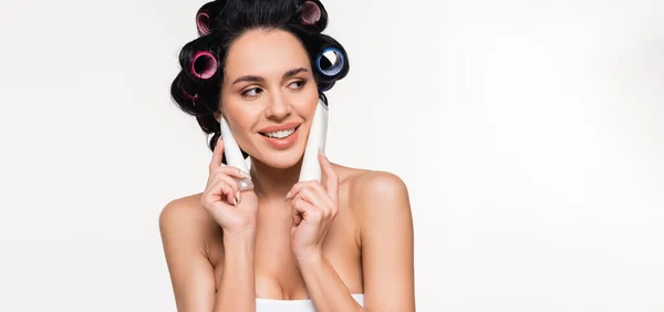 Smiling Young Woman Top Curlers Holding Cream Tubes Face Isolated — Stock Photo, Image