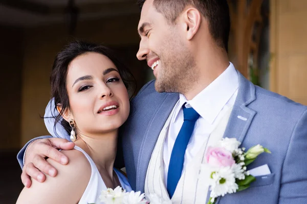 Groom Hugging Smiling Bride Looking Camera — Stock Photo, Image