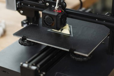 close up view of 3D printer creating plastic model in modern office
