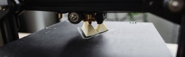 close up view of 3D printer creating plastic model on blurred background, banner