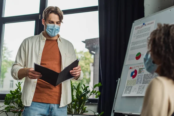 Young Man Medical Mask Holding Folder Papers Flip Chart African — Stok fotoğraf