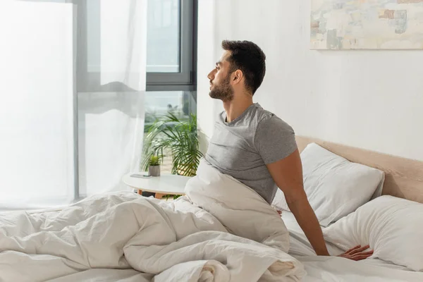 Side View Young Bearded Man Sitting Bed — Stock Photo, Image