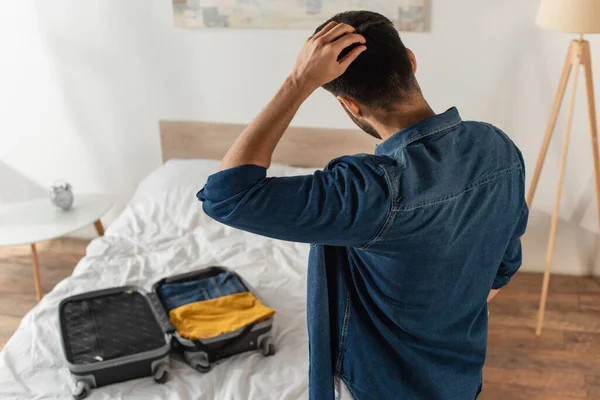 Vue Arrière Homme Tenant Main Près Tête Debout Près Valise — Photo