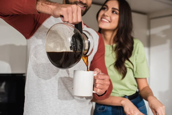 Blurred Man Pouring Coffee Smiling Girlfriend Home — Stock Photo, Image