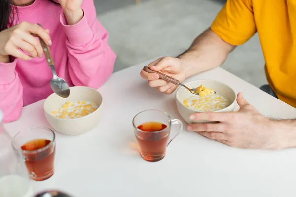 Partial View Young Couple Sitting Table Eating Corn Flakes Cups — Stock Photo, Image