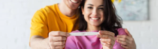 Pregnancy Test Hands Blurred Smiling Young Couple Home Banner — Stock Photo, Image