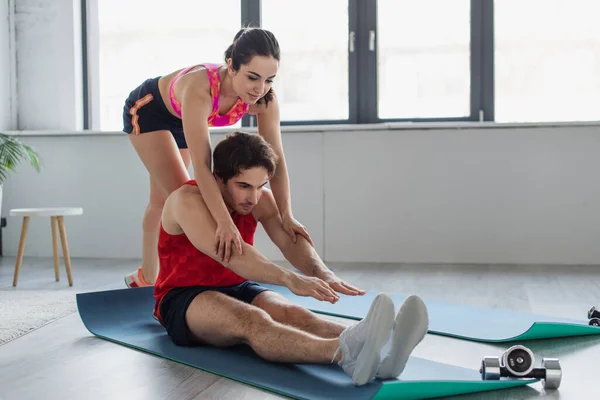 Young Woman Sportswear Touching Arms Man Doing Stretching Fitness Mat — Stock Photo, Image