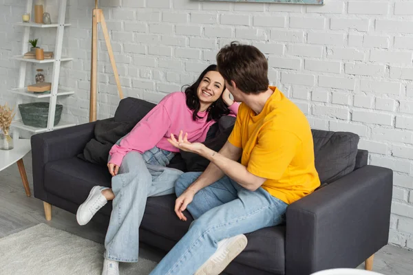 Smiling Young Woman Sitting Couch Boyfriend Gesturing Outstretched Hand Living — Stock Photo, Image