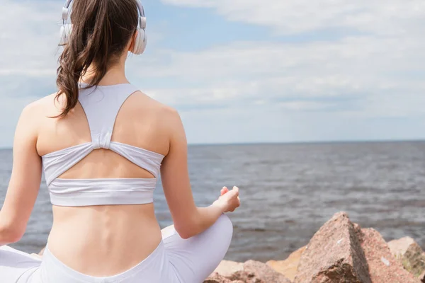 Back View Young Woman Headphones Sportswear Sitting Lotus Pose While — Stock Photo, Image