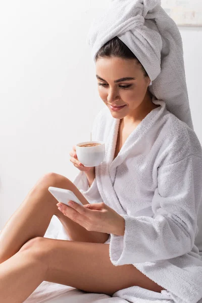 Happy Woman Towel Head Bathrobe Using Smartphone Holding Cup Coffee — Stock Photo, Image