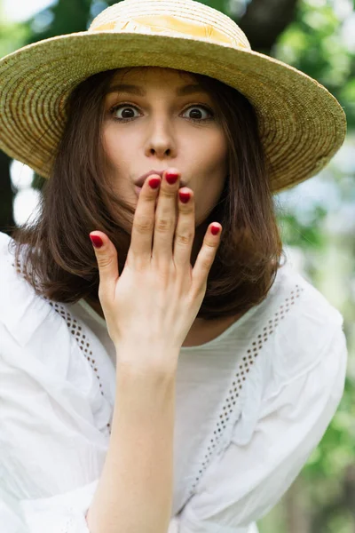 Amazed Woman Sun Hat Covering Mouth Outdoors — Stock Photo, Image