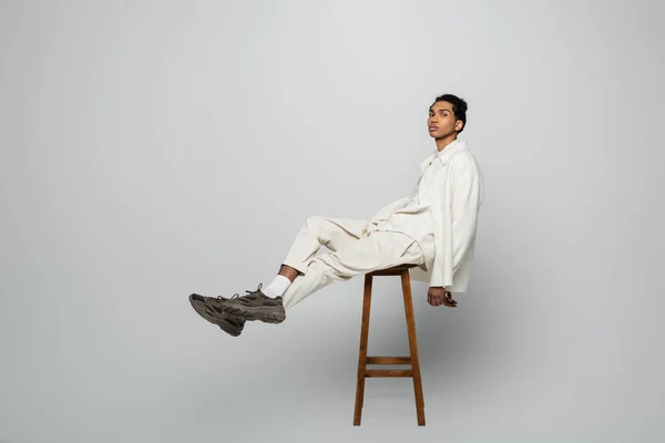 African American Man White Stylish Clothes Sitting High Stool Grey — Stock Photo, Image