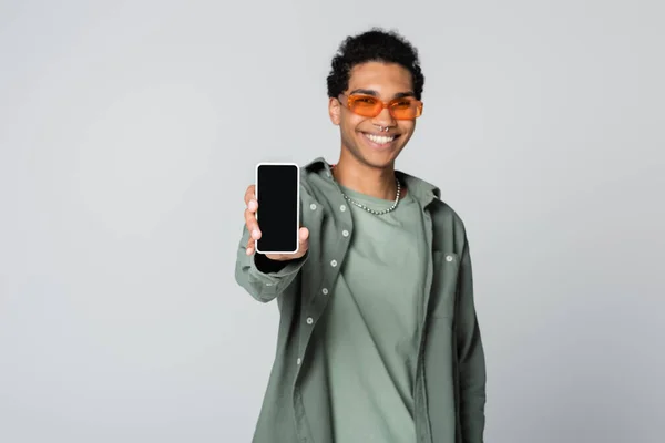 Blurred African American Man Smiling While Showing Smartphone Blank Screen — Stock Photo, Image