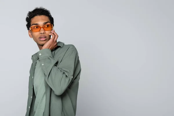 Thoughtful African American Guy Orange Eyeglasses Talking Smartphone Isolated Grey — Stock Photo, Image