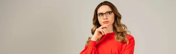Pensive Curly Woman Eyeglasses Looking Away Isolated Grey Banner — Stock Photo, Image