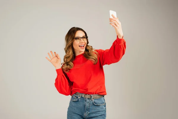 Joyful Woman Eyeglasses Having Video Chat Smartphone Isolated Grey — Stock Photo, Image