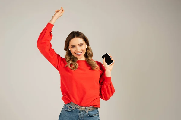 Joyful Woman Wireless Earphones Holding Smartphone Blank Screen Isolated Grey — Stock Photo, Image