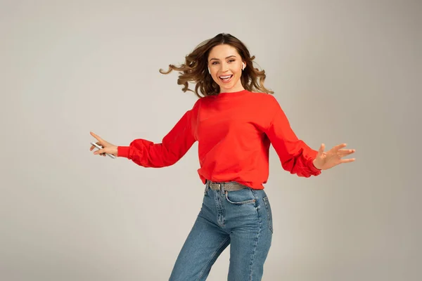 Excited Woman Wireless Earphones Holding Cellphone Isolated Grey — Stock Photo, Image