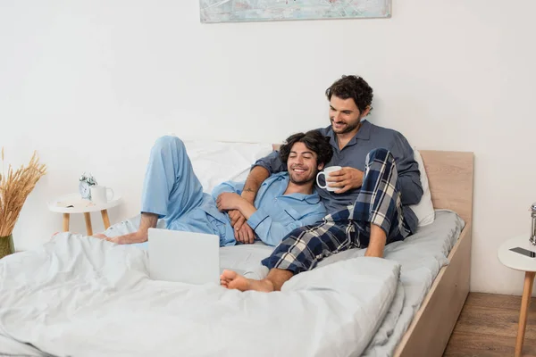 Cheerful Gay Couple Watching Film Laptop Bed — Stock Photo, Image