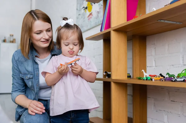 Toddler Girl Syndrome Holding Toy Plane Smiling Kindergarten Teacher — Stock Photo, Image