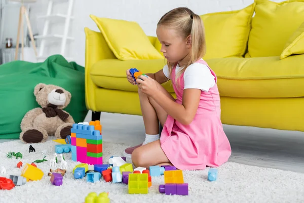 Blonde Girl Pink Dress Playing Building Blocks Carpet Kindergarten Playroom — Stock Photo, Image