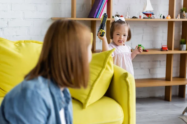 Blurred Kindergarten Teacher Looking Kid Syndrome Playing Toy Gun — Stock Photo, Image