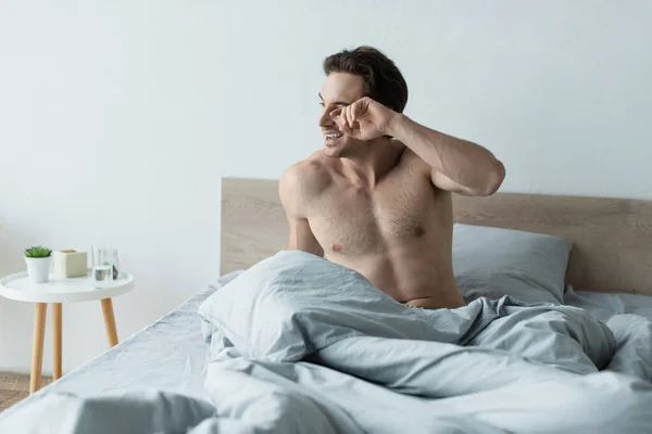 Awake Man Smiling Rubbing Eye Bed Morning — Stock Photo, Image