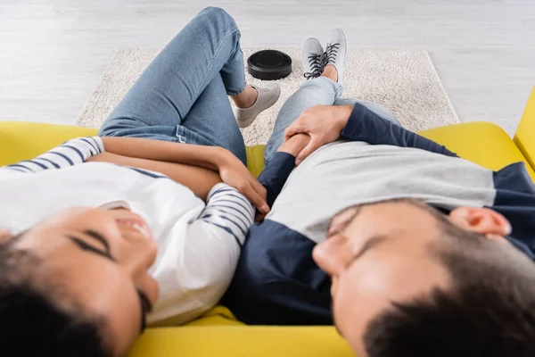 Robotic Vacuum Cleaner Blurred Interracial Couple Couch — Stock Photo, Image