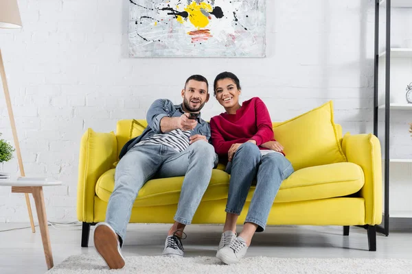 Young Multiethnic Couple Watching Film Couch Home — Stock Photo, Image