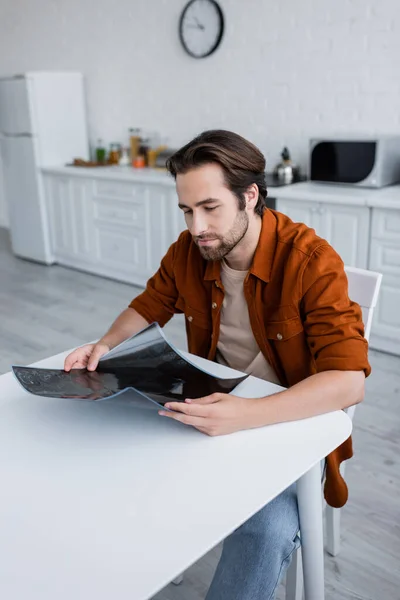 Man Sitting Kitchen Looking Mri Scan — Stock Photo, Image