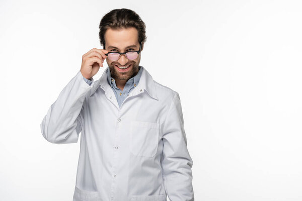 Smiling doctor holding eyeglasses isolated on white 