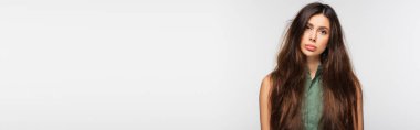 sad young woman with problematic tangled long hair isolated on grey, banner clipart
