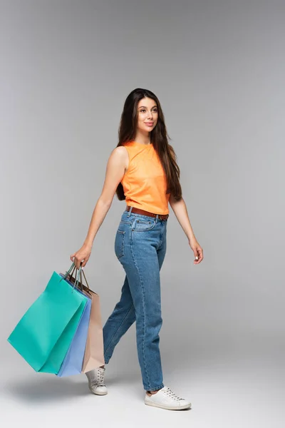 Full Length Brunette Young Woman Holding Shopping Bags Walking Grey — Stock Photo, Image