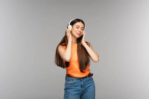 Young Woman Denim Jeans Wireless Headphones Listening Music While Smiling — Stock Photo, Image