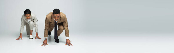 african american business people in starting pose before running on grey, banner