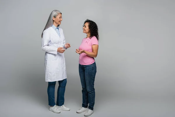 Cheerful Asian Doctor Talking African American Patient Ribbon Breast Cancer — Stock Photo, Image