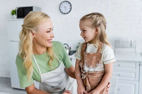 Happy Woman Looking Daughter Apron Flour Stains Kitchen — Stock Photo, Image