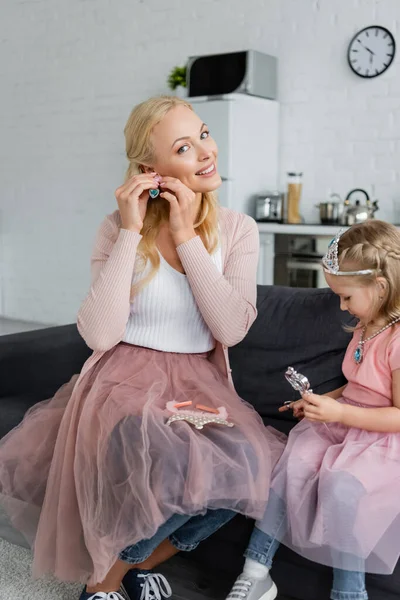 Smiling Woman Putting Earring Daughter Toy Crown — Stock Photo, Image