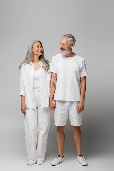 Full Length Happy Interracial Mature Couple Holding Hands Grey — Stock Photo, Image