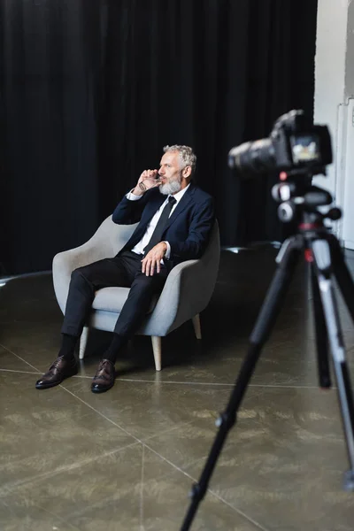 Bearded Businessman Drinking Water Blurred Digital Camera Tripod — Stock Photo, Image