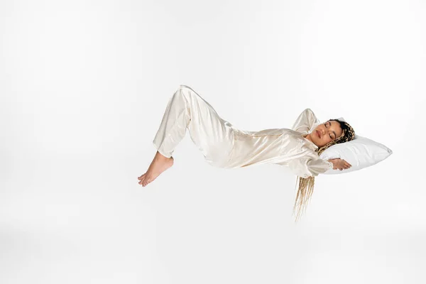 Young African American Woman Sleeping Silk Pajamas While Levitating Isolated — Stock Photo, Image