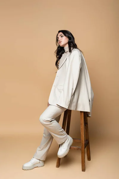 Full Length Young Woman Suit Posing While Sitting Wooden Stool — Stock Photo, Image