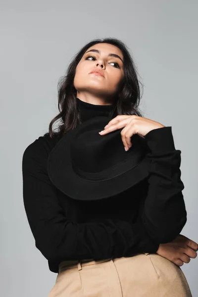 Young Model Holding Black Fedora Hat Looking Away Isolated Grey — Stock Photo, Image